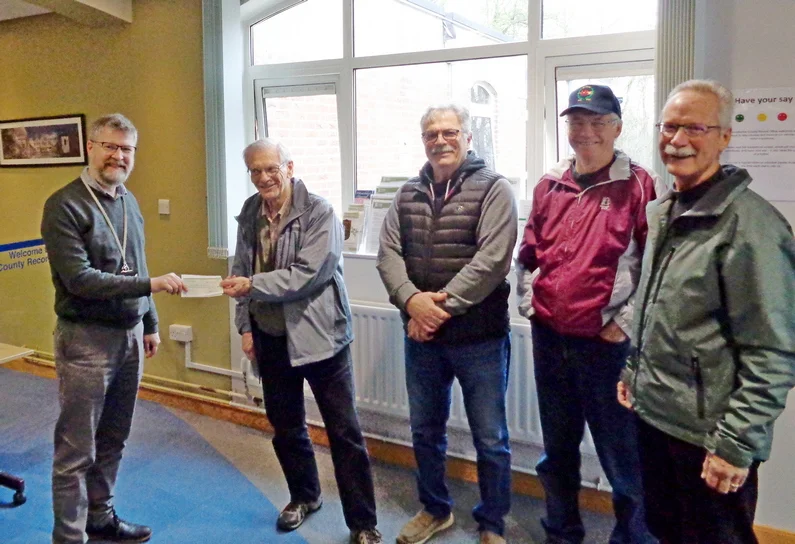 Rob Eyre, senior archivist of the Warwick County Record Office, receiving a cheque from Larry Paterson of the AHC USA.